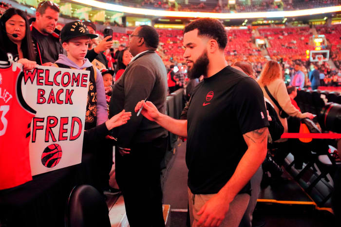 Rockets guard Fred VanVleet (5) goes to sign an autograph for a fan before a game against the Toronto Raptors at Scotiabank Arena.